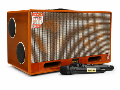 Oris TX 252 portable karaoke speaker in a wood cabinet with its two wireless microphones